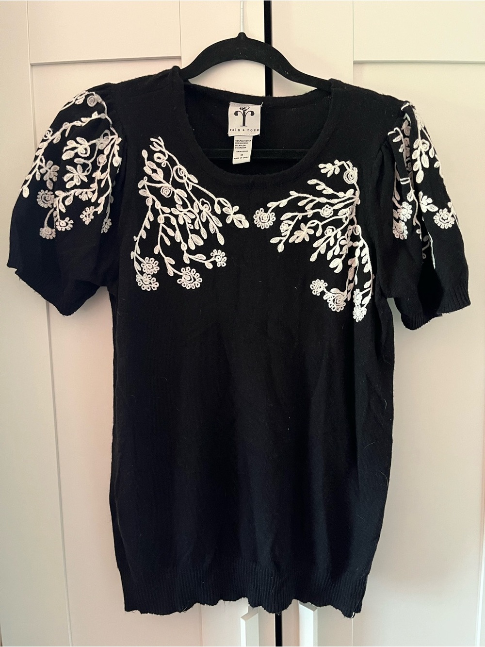 Anthropologie Black Short-Sleeve Knit Top with White Floral Appliqué
